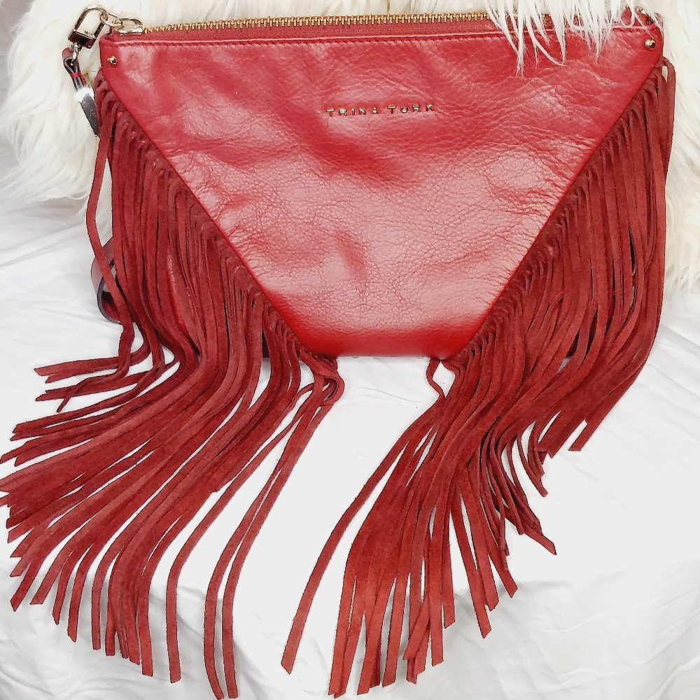 Deep Red Trina Turk Fringe bag with wristlet. Like New. Medium size.